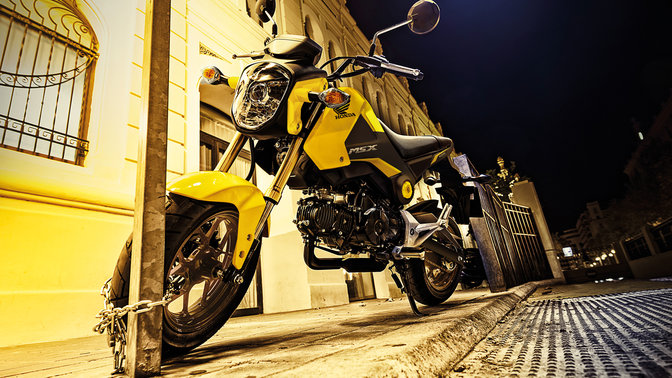 Over the shoulder view of Varadero 125 instruments, handlebars and road ahead (Location).