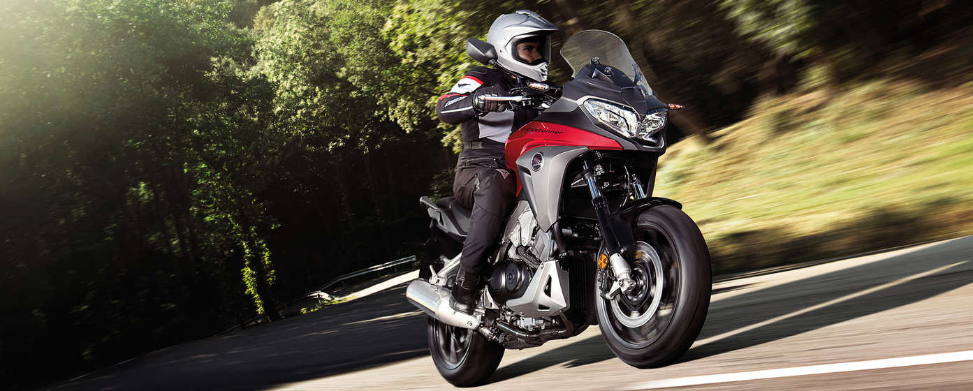 Front-facing Honda Crossrunner, off-road location with rider.