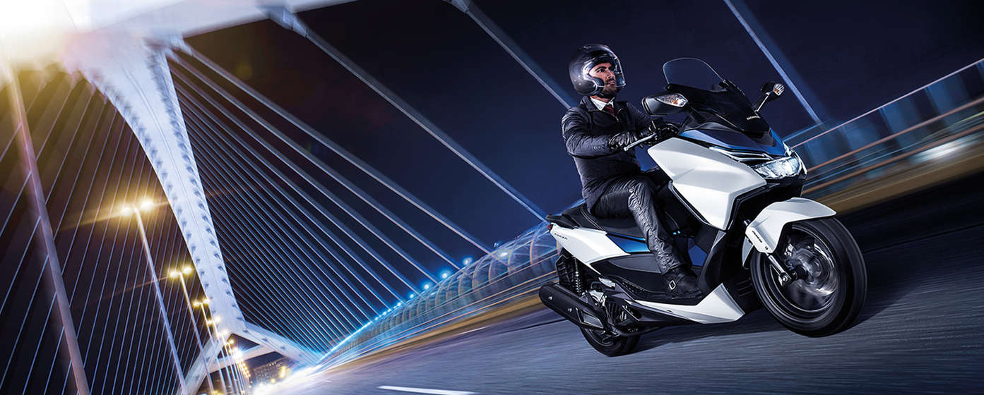 Side on, leftt-facing silver Honda s-wing in street location.