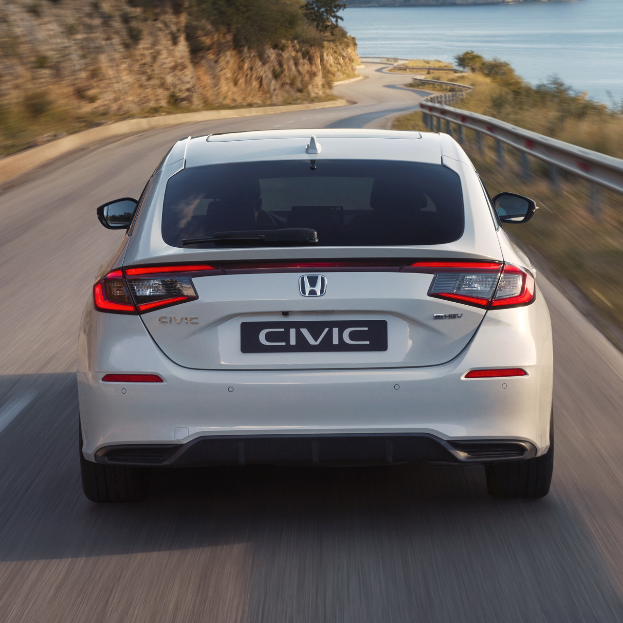 Gros plan de l'arrière de la Honda Civic Hybrid, en mouvement, sur une autoroute.