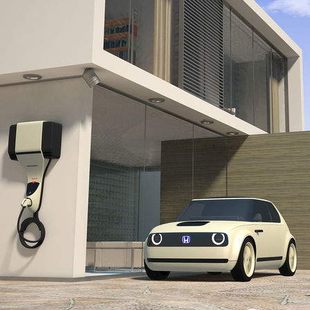 Vue de trois-quarts avant de la Honda Urban EV Concept avec borne de charge.