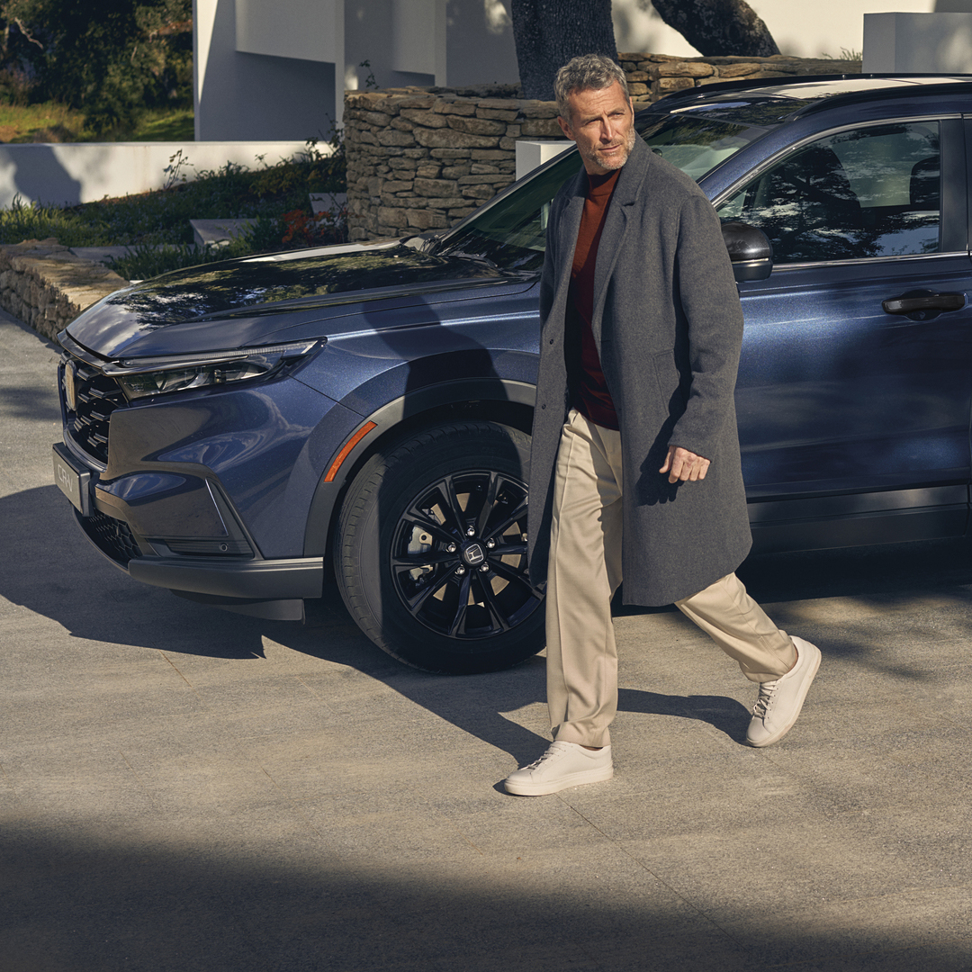 Vue de côté du Honda CR-V hybride avec mannequin.