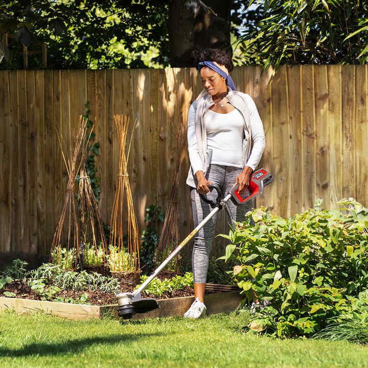 Femme utilisant un taille-haie sans fil
