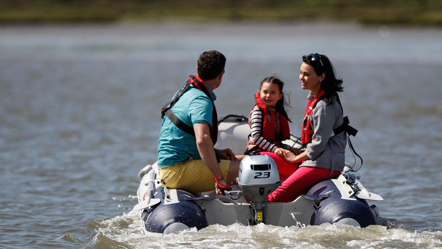 Family on a lake in a Honda BF2.3.