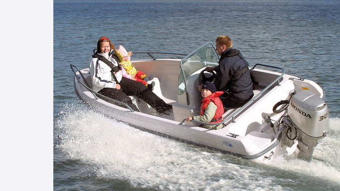 Boat with BF30 engine, being used by models, coastal location.