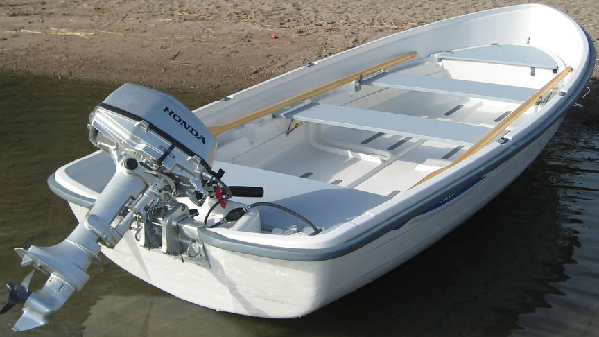 Boat on sand with Honda engine attached.