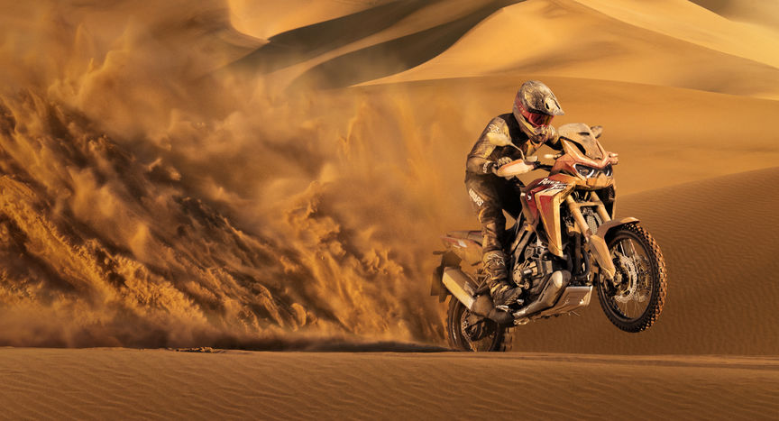 Honda Africa Twin, vue de trois quarts avant droit, pilotée dans le sable
