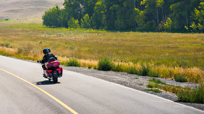 Vue de trois quarts arri&egrave;re de la moto routi&egrave;re Honda Gold Wing, &agrave; la campagne.